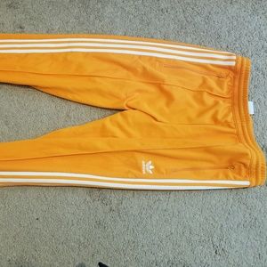 Orange adidas track pants